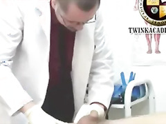 The doctor examines the young twinks foreskin